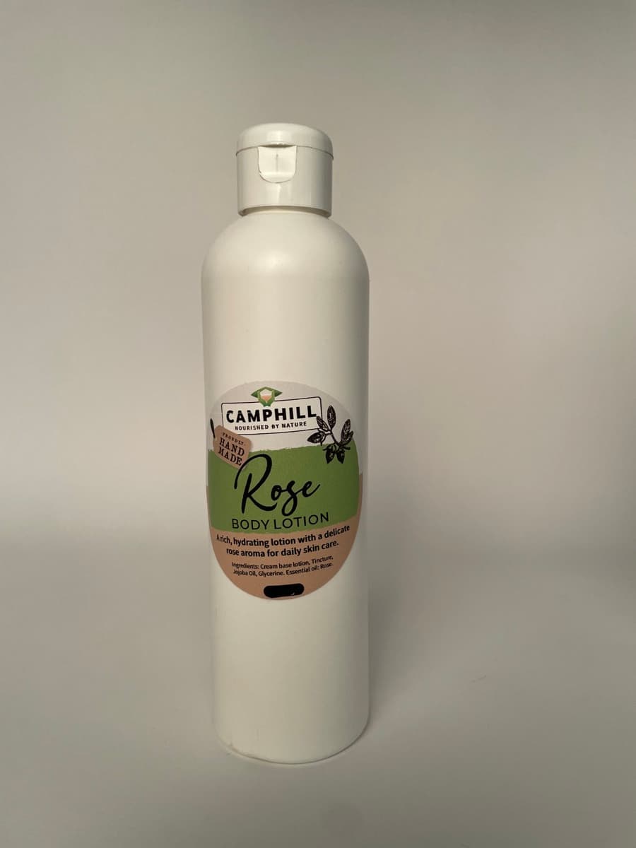 A 250ml white bottle of Camphill Rose Body Lotion.