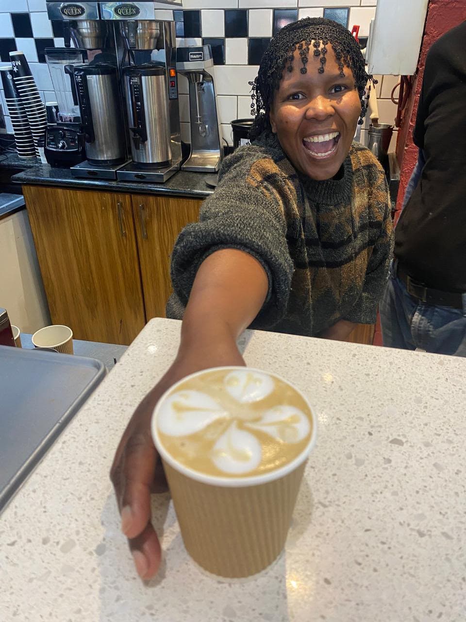 one resident proudly holding her freshly made coffee