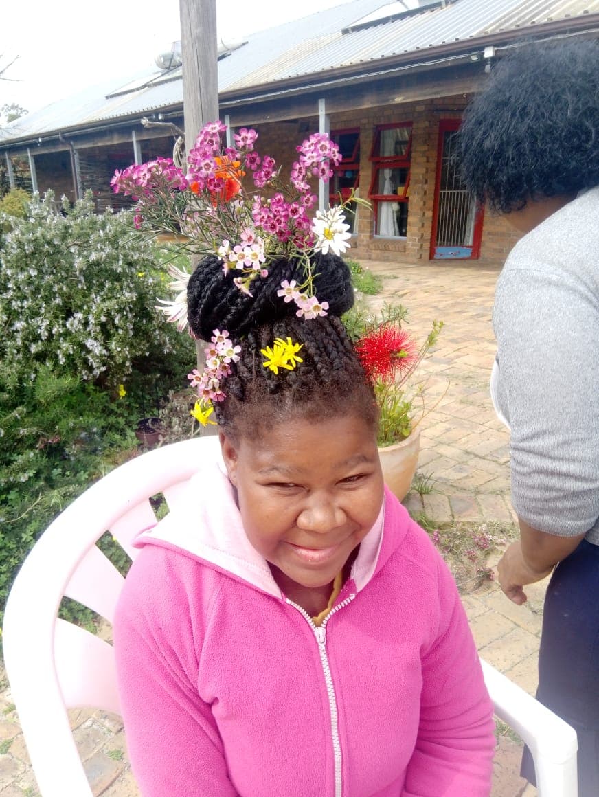 resident with flowers in her hair